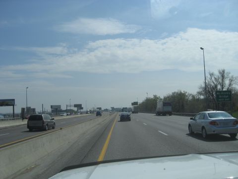 1978 Ford Bronco - Driving on a highway with traffic and a sign indicating the next exit for McKinley Bridge.
