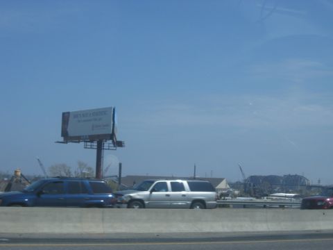 1978 Ford Bronco - Vehicles travel along a highway under a bright blue sky, with a large billboard visible.