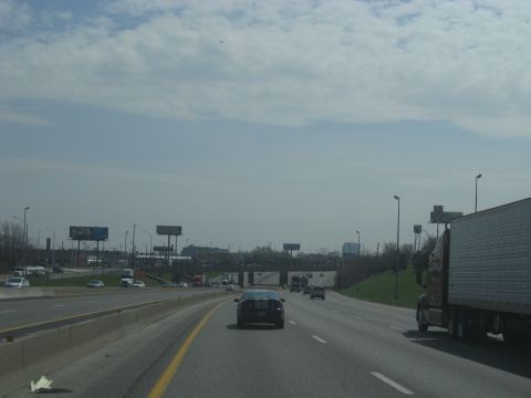 1978 Ford Bronco - A view of highway traffic under a cloudy sky with several vehicles on the road.
