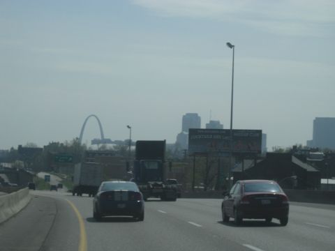 1978 Ford Bronco - A highway scene shows the Gateway Arch and city skyline in the distance, with several vehicles on the road.