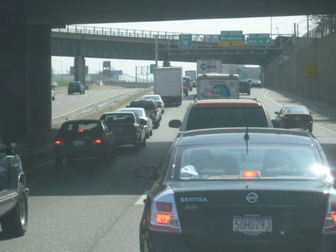 1978 Ford Bronco - Traffic is backed up on the highway, with multiple lanes of vehicles at a standstill.