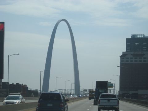 1978 Ford Bronco - Traffic moves along a highway with the Gateway Arch visible in the distance.