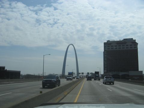 1978 Ford Bronco - Driving towards the Gateway Arch on a highway with traffic under a cloudy sky.