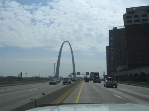 1978 Ford Bronco - Driving on a highway with the Gateway Arch visible in the distance and city buildings to the right.