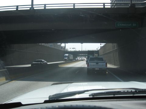 1978 Ford Bronco - Highway traffic moves under an overpass, with a sign indicating Chestnut St.