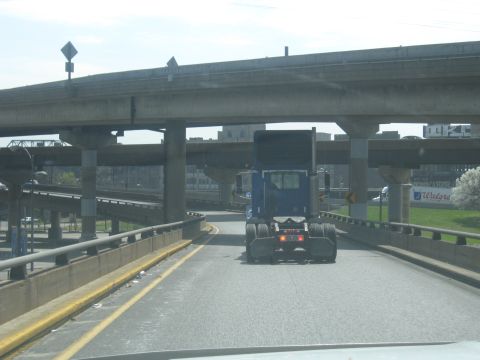 1978 Ford Bronco - Driving behind a semi-truck on a highway with multiple overpasses overhead.