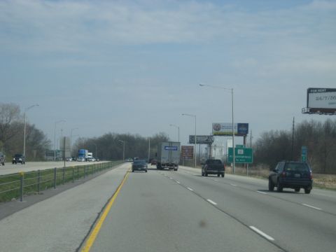 1978 Ford Bronco - Driving on a multi-lane highway with various vehicles and billboards along the roadside.