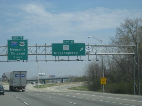 1978 Ford Bronco - A semi-trailer truck travels on a highway under overhead signs indicating exits for Memphis and Kingshighway.