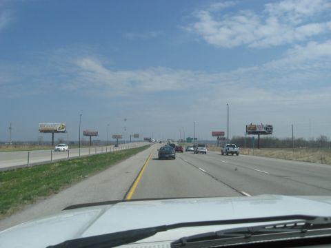 1978 Ford Bronco - View from a car driving on a highway with multiple lanes and billboards visible.