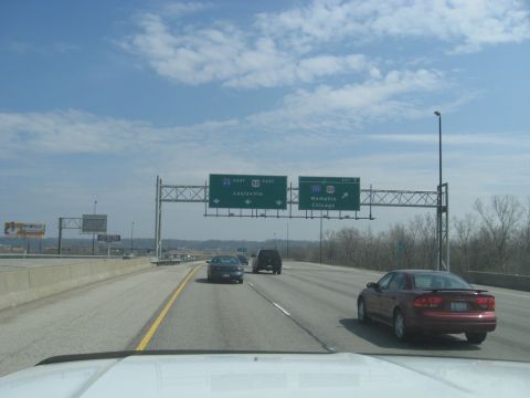 1978 Ford Bronco - A highway scene with directional signs and several vehicles driving on a sunny day.