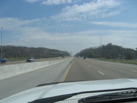 1978 Ford Bronco - A view from a vehicle traveling on a highway with other cars and a distant McDonald's sign.