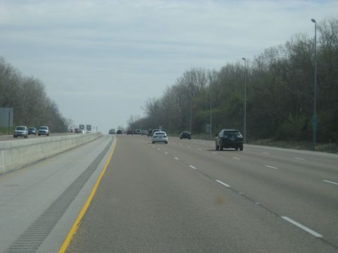 1978 Ford Bronco - Traffic moves along a multi-lane highway under an overcast sky.