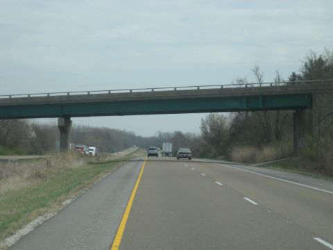 1978 Ford Bronco - A highway scene unfolds beneath an overpass, with several vehicles traveling in the distance.