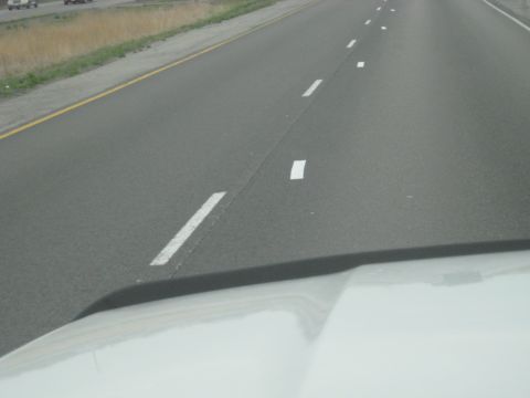 1978 Ford Bronco - Driving down the highway with lane markers guiding the way.