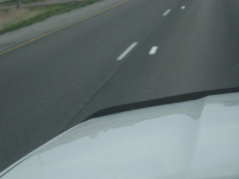 1978 Ford Bronco - View from the driver's seat of a white vehicle on a highway.