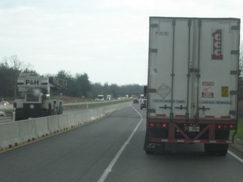 1978 Ford Bronco - A tractor-trailer travels down a highway, with a P&H crane visible on the left side of the road.