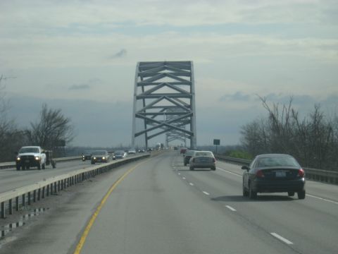 1978 Ford Bronco - Traffic moves across a large bridge under an overcast sky.