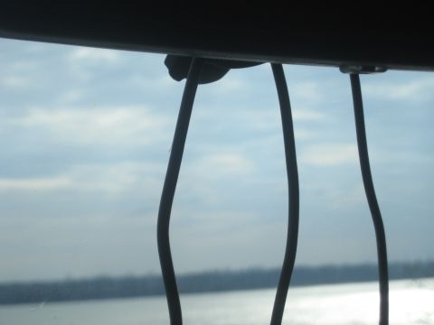 1978 Ford Bronco - Looking out over water and a distant treeline through a protective wire barrier.