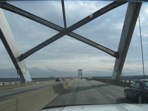 1978 Ford Bronco - Driving across a bridge with multiple lanes of traffic under a cloudy sky.