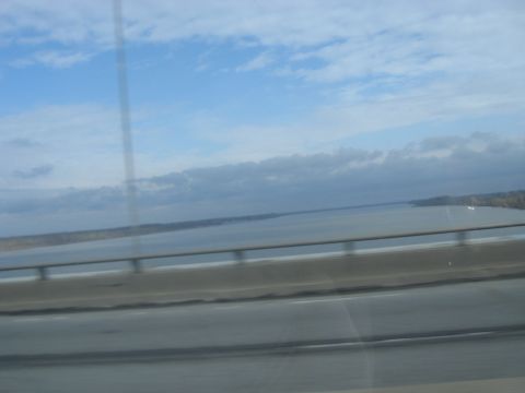1978 Ford Bronco - Driving over a bridge with a scenic view of the water and sky.