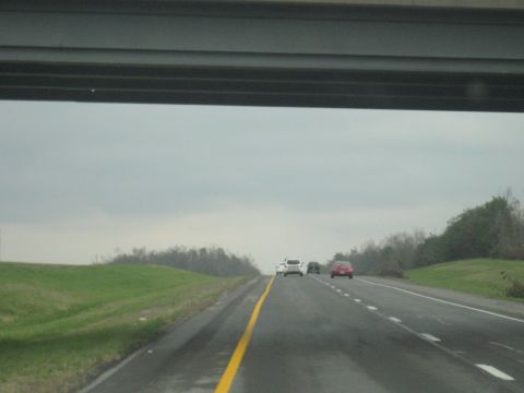 1978 Ford Bronco - A cloudy day on the highway with several vehicles ahead.