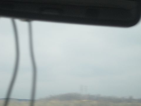1978 Ford Bronco - View from inside a vehicle looking out at a distant, hazy landscape under an overcast sky.