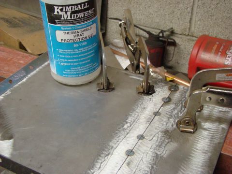 1948 Jeep Wrangler - Preparing a metal sheet for welding with heat protection gel and clamps.