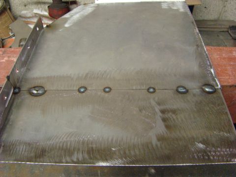 1948 Jeep Wrangler - A metal panel shows a series of welds, indicating recent fabrication or repair work.