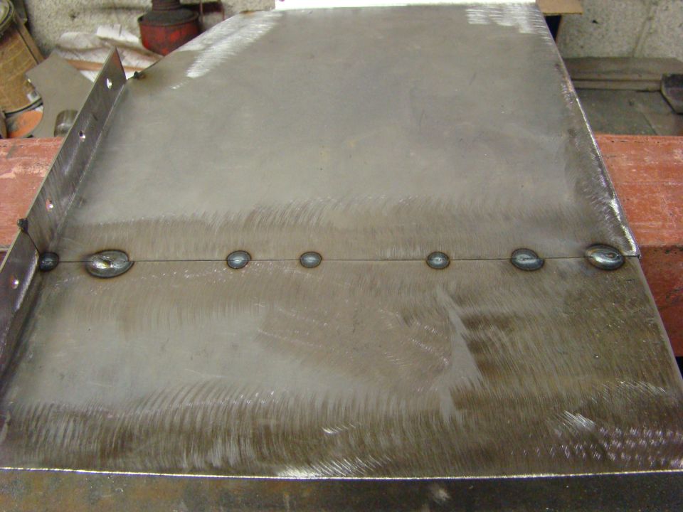 metal panel with a line of welds down the middle