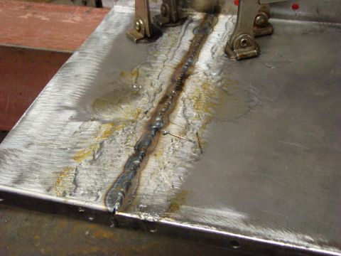 1948 Jeep Wrangler - A close-up view of a freshly welded metal seam, showing the texture and some discoloration.