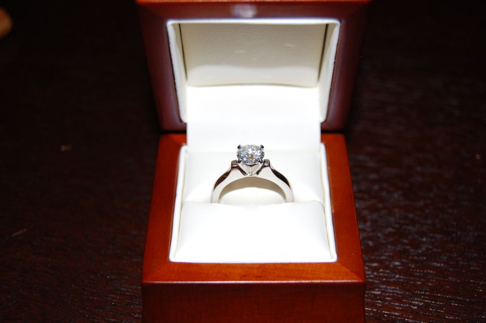 Diamond ring in an open wooden jewelry box