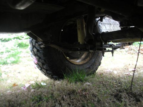1987 Suzuki Samurai - Underside view of a 1987 Suzuki Samurai showing the rear leaf spring suspension and tire.