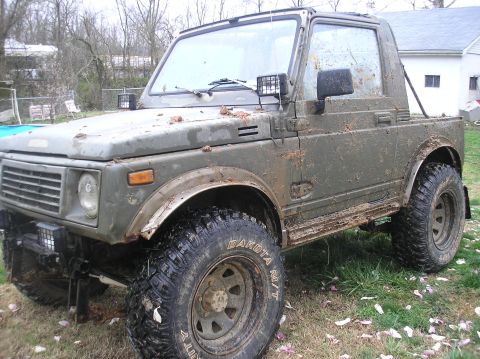 1987 Suzuki Samurai - This Suzuki Samurai is covered in mud, suggesting it has been off-roading.
