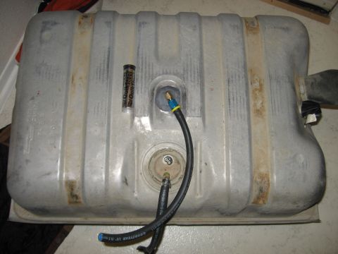 1979 Ford Bronco - Fuel tank with attached hoses and a QuikSteel tube, likely for repairs.