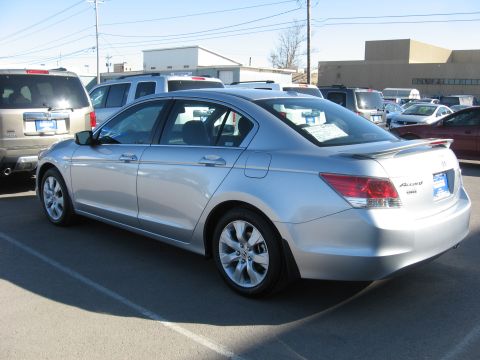 2009 Honda Accord - Rear 3/4 view of a silver 2009 Honda Accord sedan parked in a lot with other vehicles.