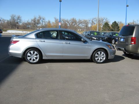2009 Honda Accord - A silver sedan is parked on an asphalt lot with other vehicles nearby under a clear blue sky.