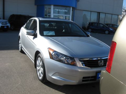 2009 Honda Accord - A silver 2009 Honda Accord is parked in front of a dealership. The vehicle's grille and headlights are clearly visible.