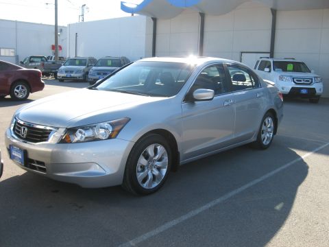 2009 Honda Accord - Silver sedan parked in a lot with other vehicles in the background.