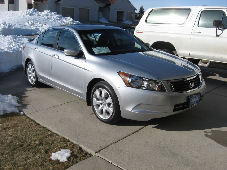 Silver 2009 Honda Accord 3q-front view with a white SUV behind it