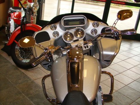 2009 Harley-Davidson FLH - Close-up of a 2009 Harley-Davidson FLH dashboard and handlebars, with another motorcycle in the background.