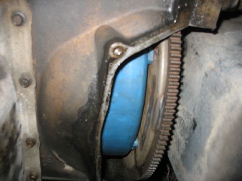 1995 Ford C-350 (Centurion Conversions) - Close-up view of a vehicle's transmission bell housing and flexplate, showing mechanical components.
