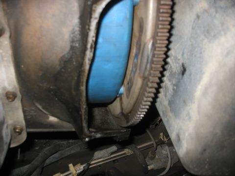 1995 Ford C-350 (Centurion Conversions) - Close-up view of a transmission bell housing and flexplate, showing a blue component.