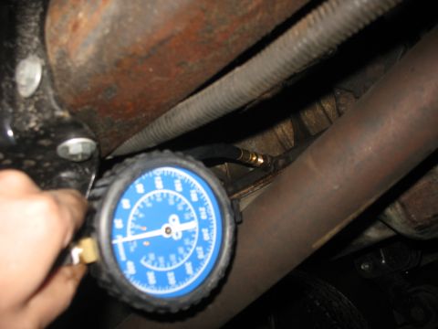 1995 Ford C-350 (Centurion Conversions) - Fuel pressure gauge connected to engine component for testing.