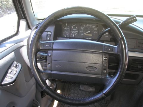 1995 Ford Bronco - Interior view of a 1995 Ford Bronco, focusing on the steering wheel and instrument cluster.