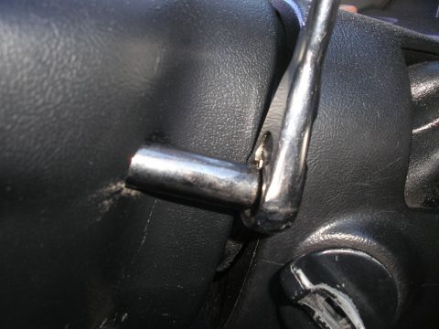 1995 Ford Bronco - Close-up of a chrome lever connected to the steering column of a vehicle.