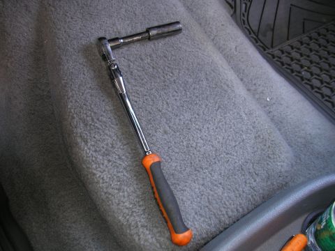 1995 Ford Bronco - A ratchet and socket set is placed on the passenger seat of a vehicle.