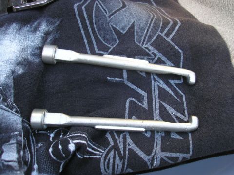1995 Ford Bronco - Two tire irons are shown on a black cloth with a graphic design.
