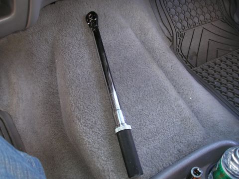 1995 Ford Bronco - Torque wrench on vehicle floor next to a rubber mat.
