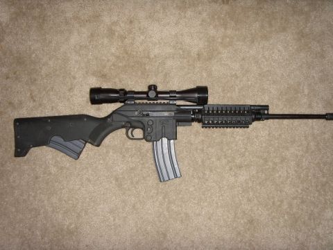 1978 Ford Bronco - A rifle with a scope and extended magazine is shown against a carpeted background.
