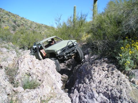 1986 Toyota Hilux - This heavily modified 1986 Toyota Hilux is shown navigating a challenging rocky trail.
